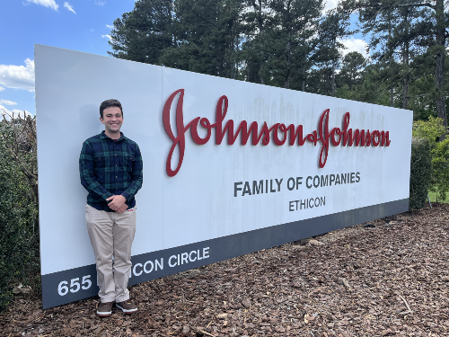 Max Harris in front of johnson and johnson sign