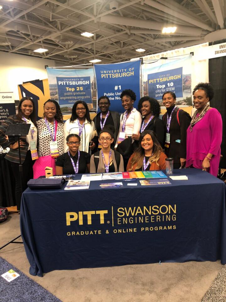 Students at a table smiling