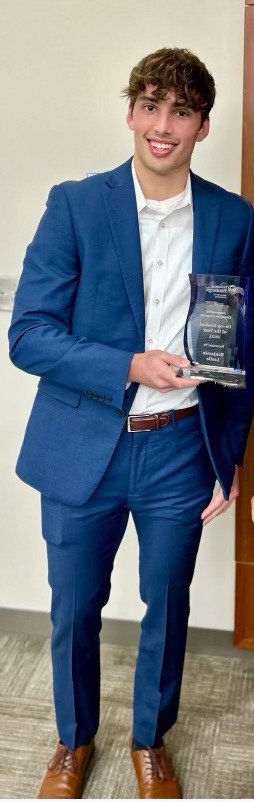 Ben Leslie holding the co-op award