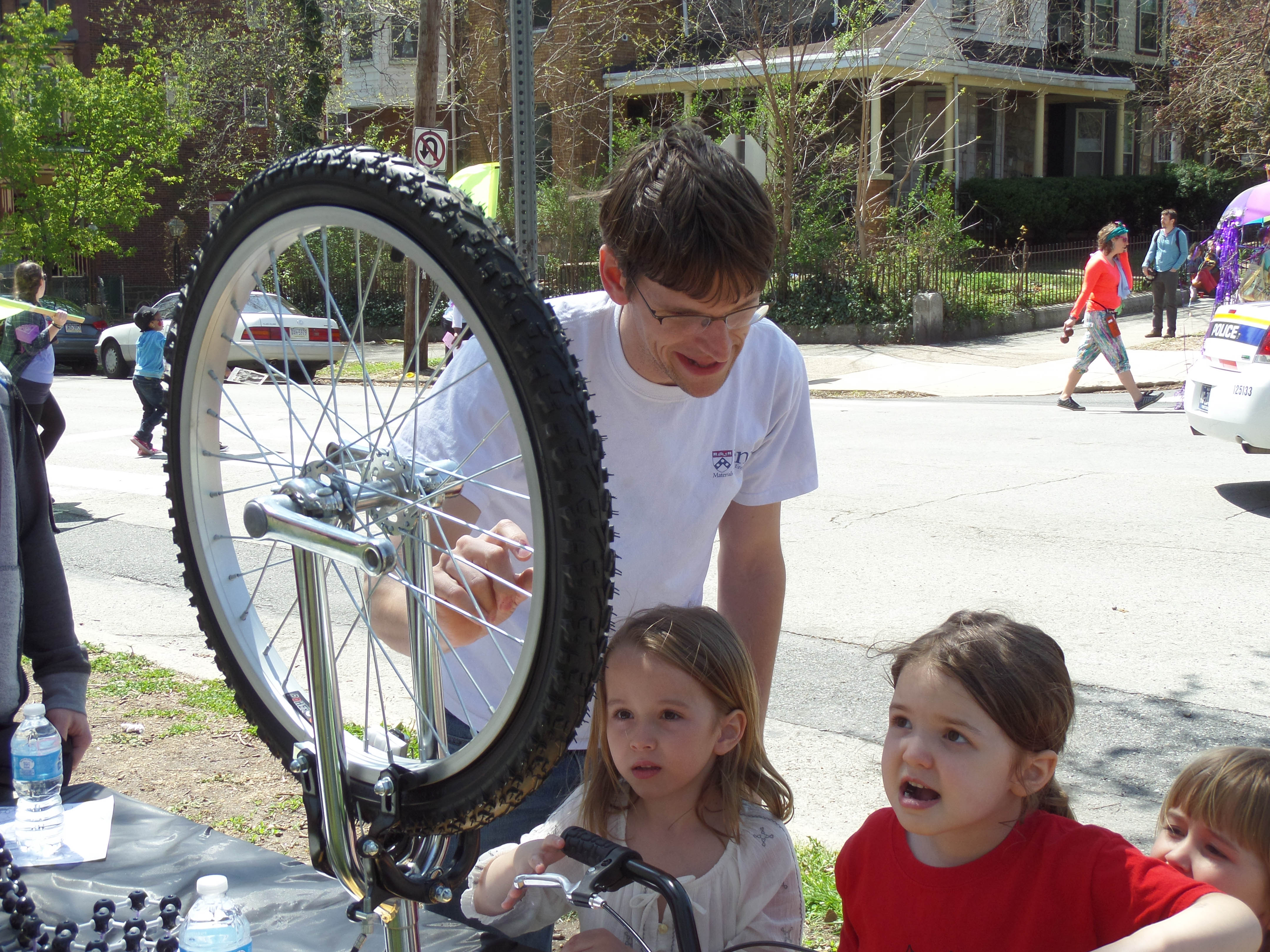 Tevis doing an experiment with children and a bike wheel