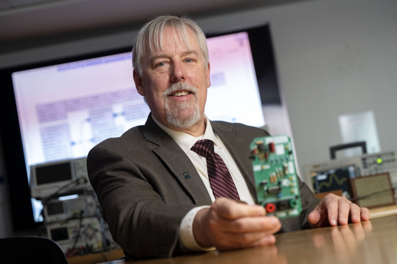 Jacobs lab - Steven Jacobs holding a circuit board. Photo by Thomas Altany. Jacobs lab