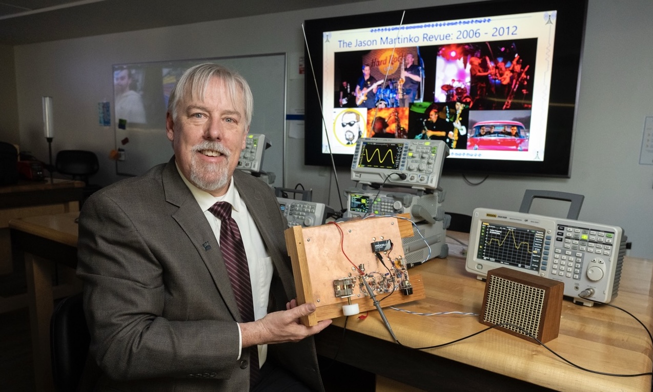 Steven Jacobs holding a radio. Photo by Thomas Altany.