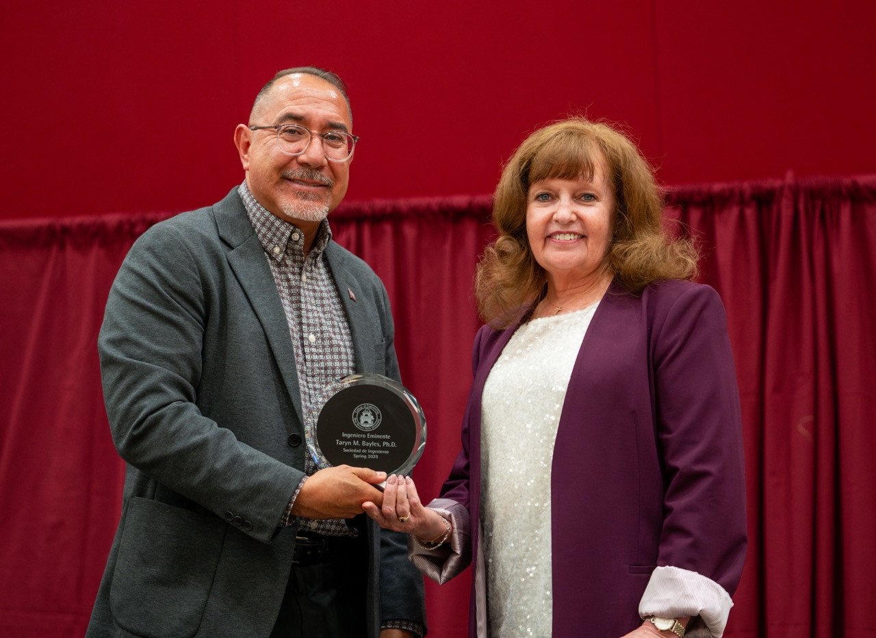 Spring Grad 25_024 Bayles Large - David Jáuregui, interim dean of the College of Engineering at New Mexico State University, presents Dr. Taryn Bayles with the prestigious "Ingeniero Eminente" award at the Spring 2025 Order of the Engineer and Sociedad De Ingenieros ceremony. Photo courtesy of Stella Aude/NMSU. Spring Grad 25_024 Bayles Large