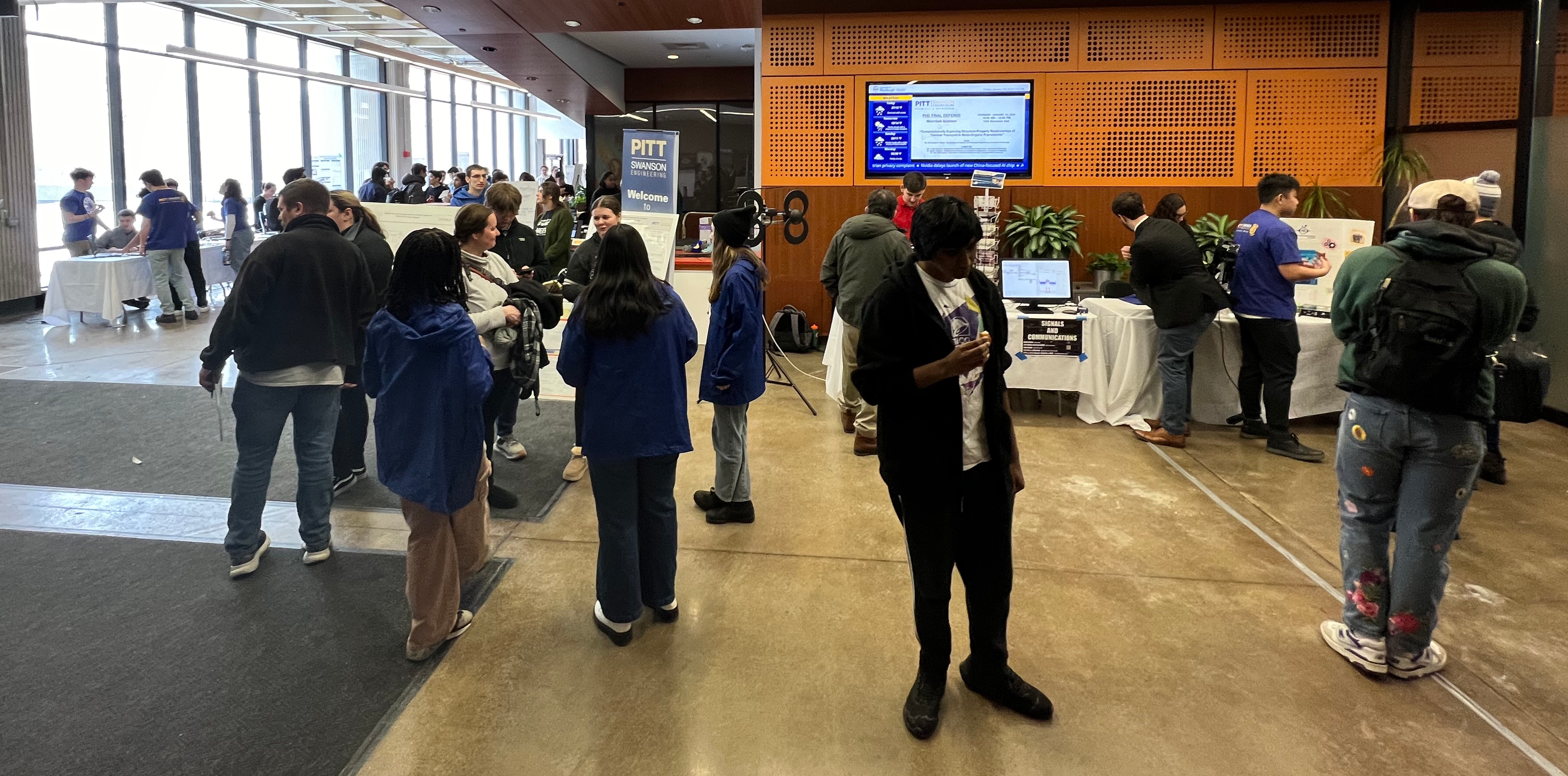 People in the lobby of Benedum Hall