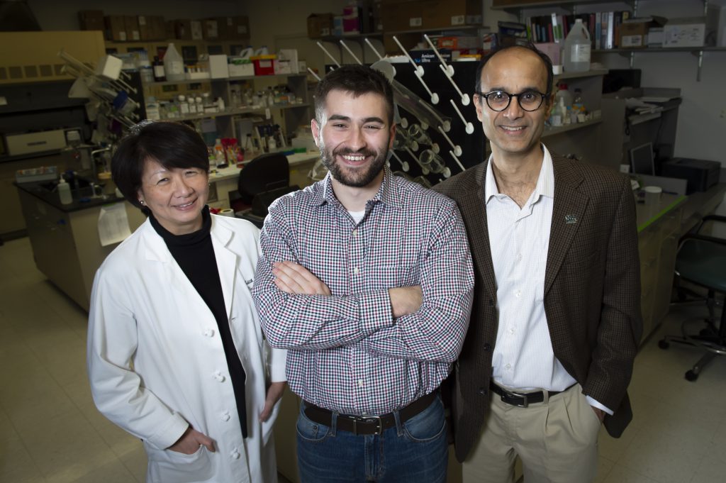 Joseph Pugar, co-founder and CEO of Aruga Technologies (center) poses in the lab of Dr. Edith Tzeng (left), Chief of Vascular Surgery, V.A. Hospital, and Chemical Engineering professor and Sachin Velankar (right)