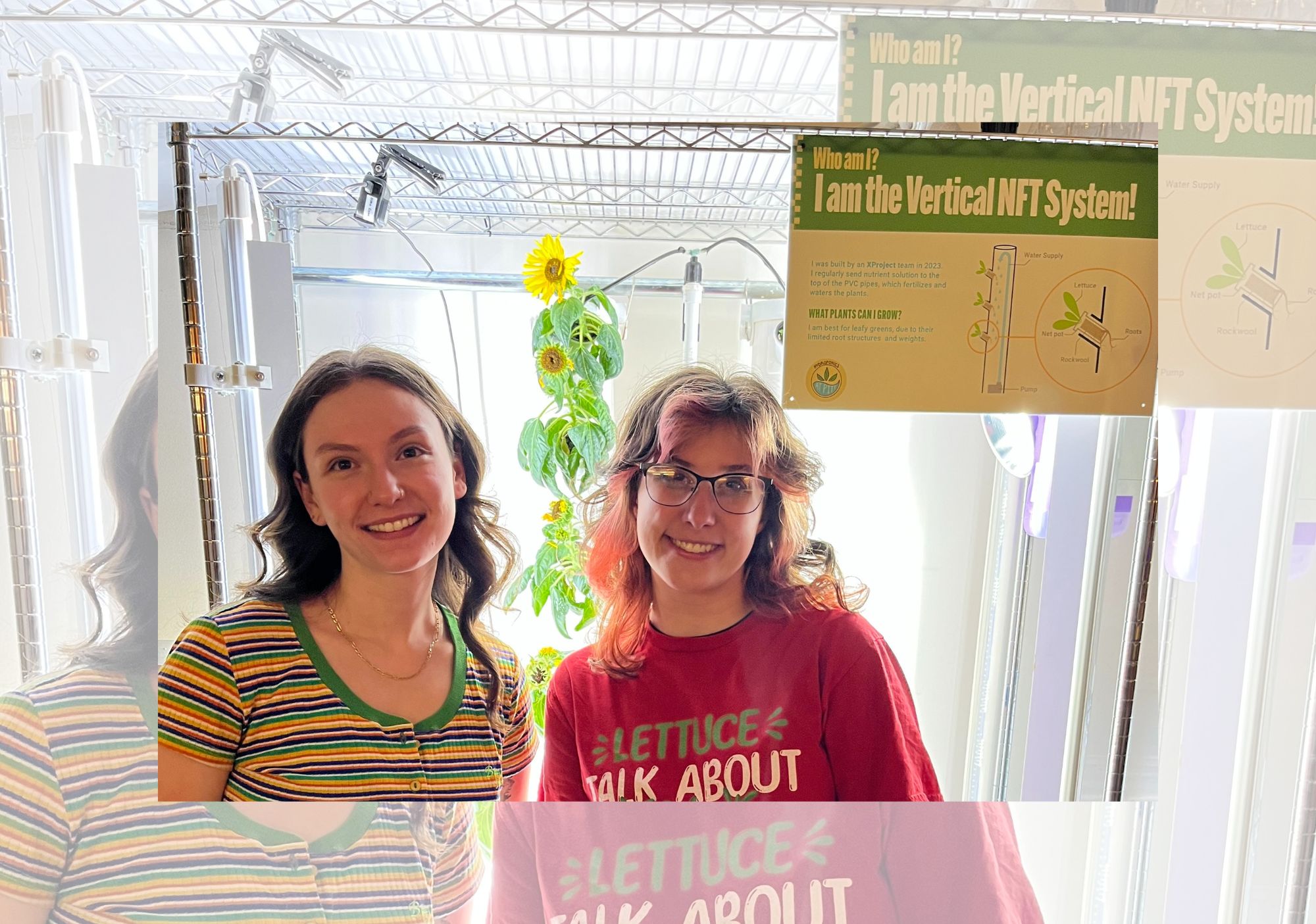 Phoebe and Samantha in front of  sunflowers and new signage