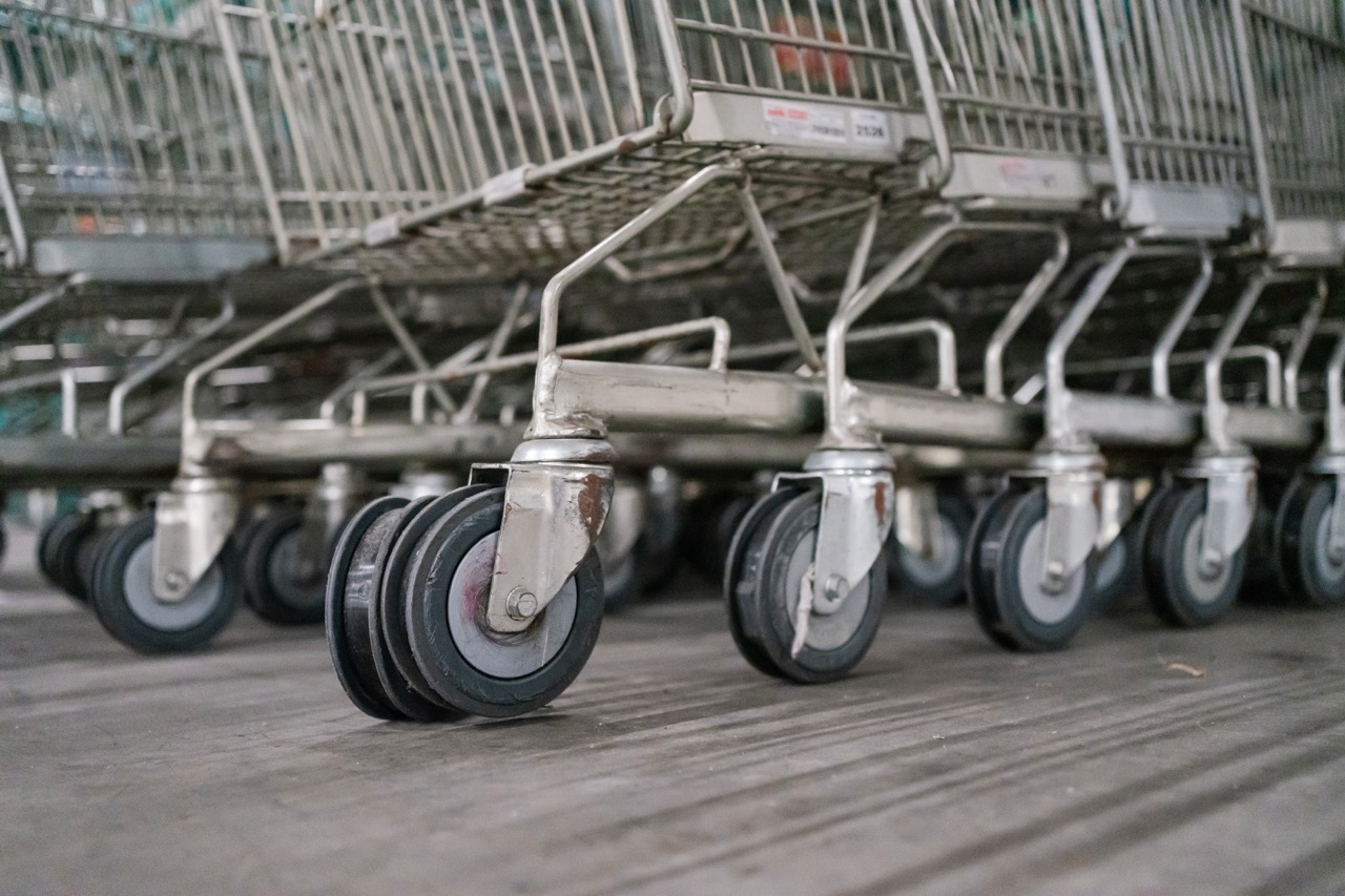 Close-up shot of shopping cart wheels with worn-out rubber, stacked together in a storage area.