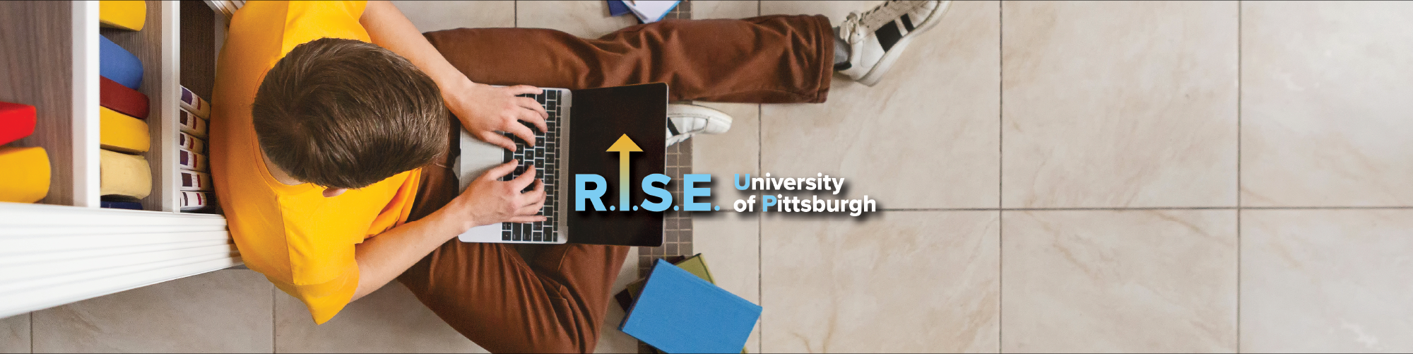 rise up banner image of student working at laptop