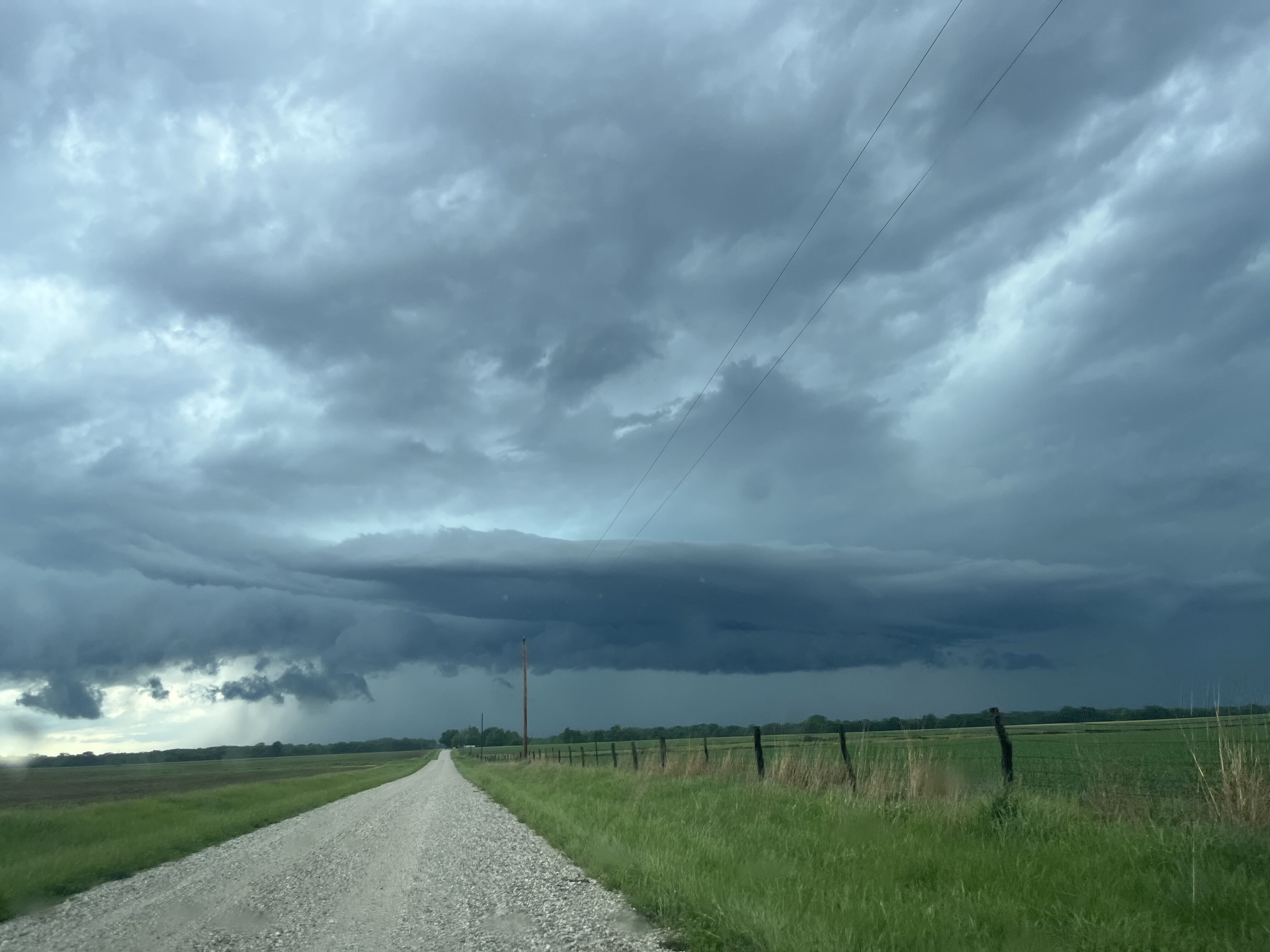 Storm clouds forming over a country road.