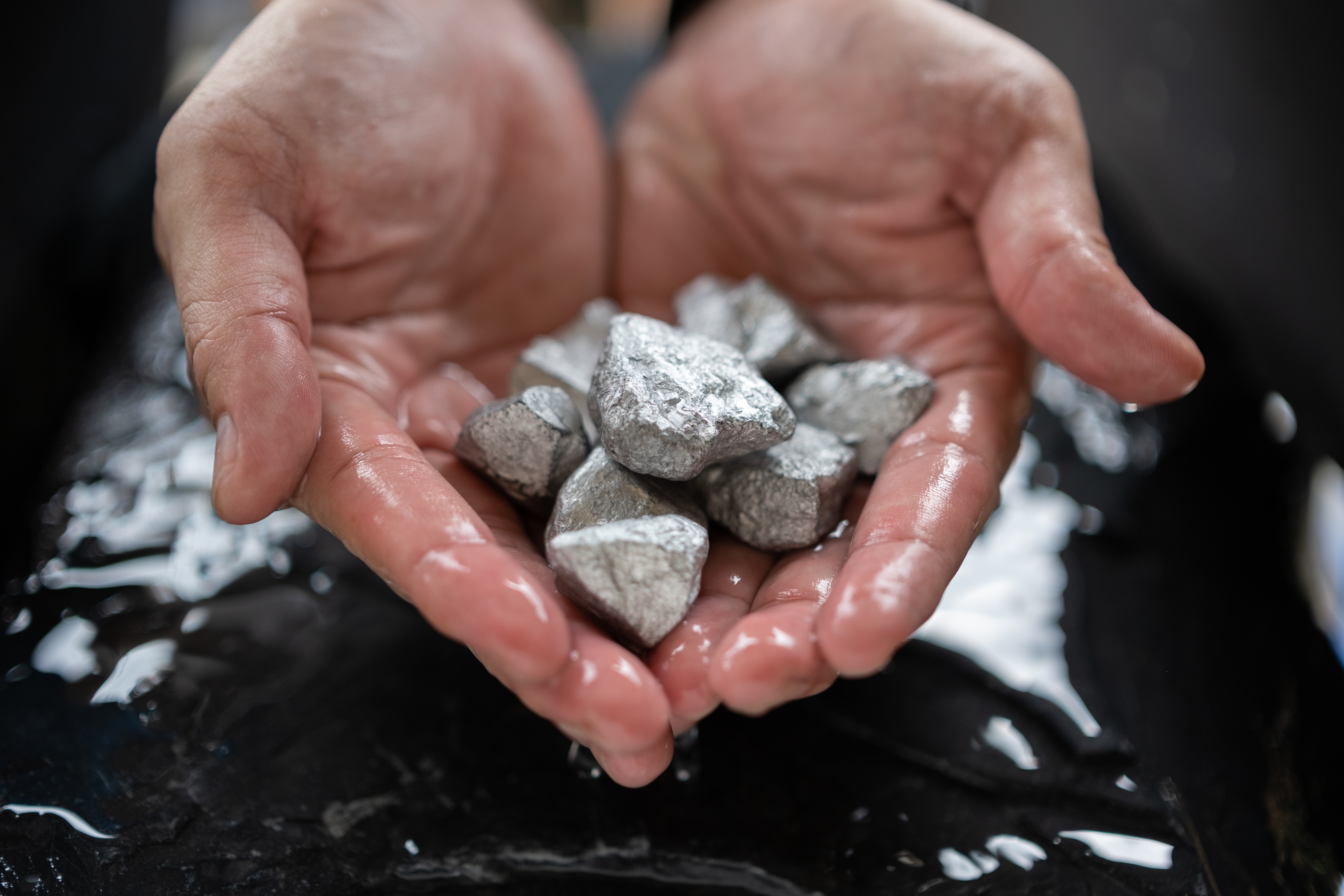 Hands holding rare earth