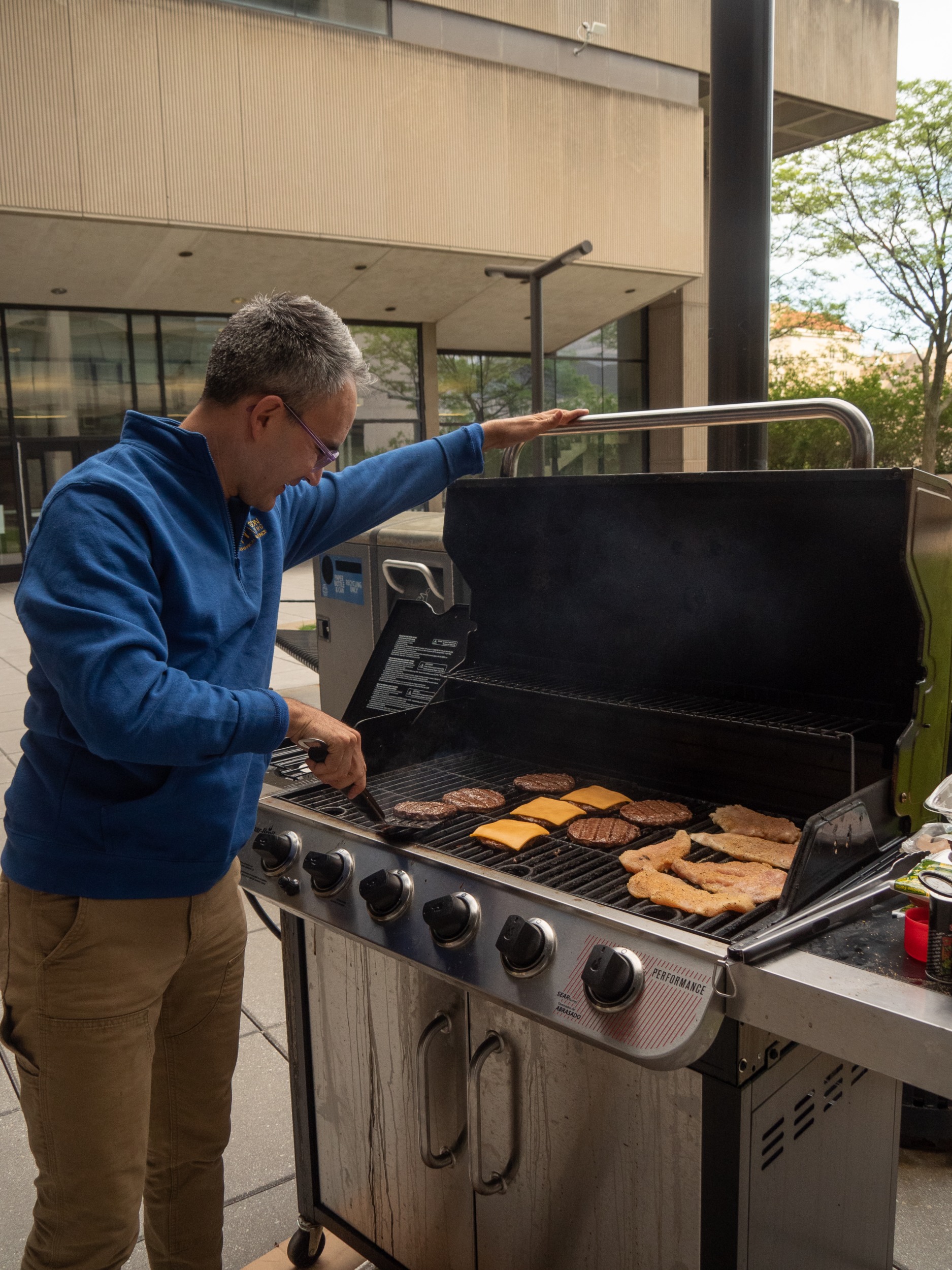 A professor grilling burgers