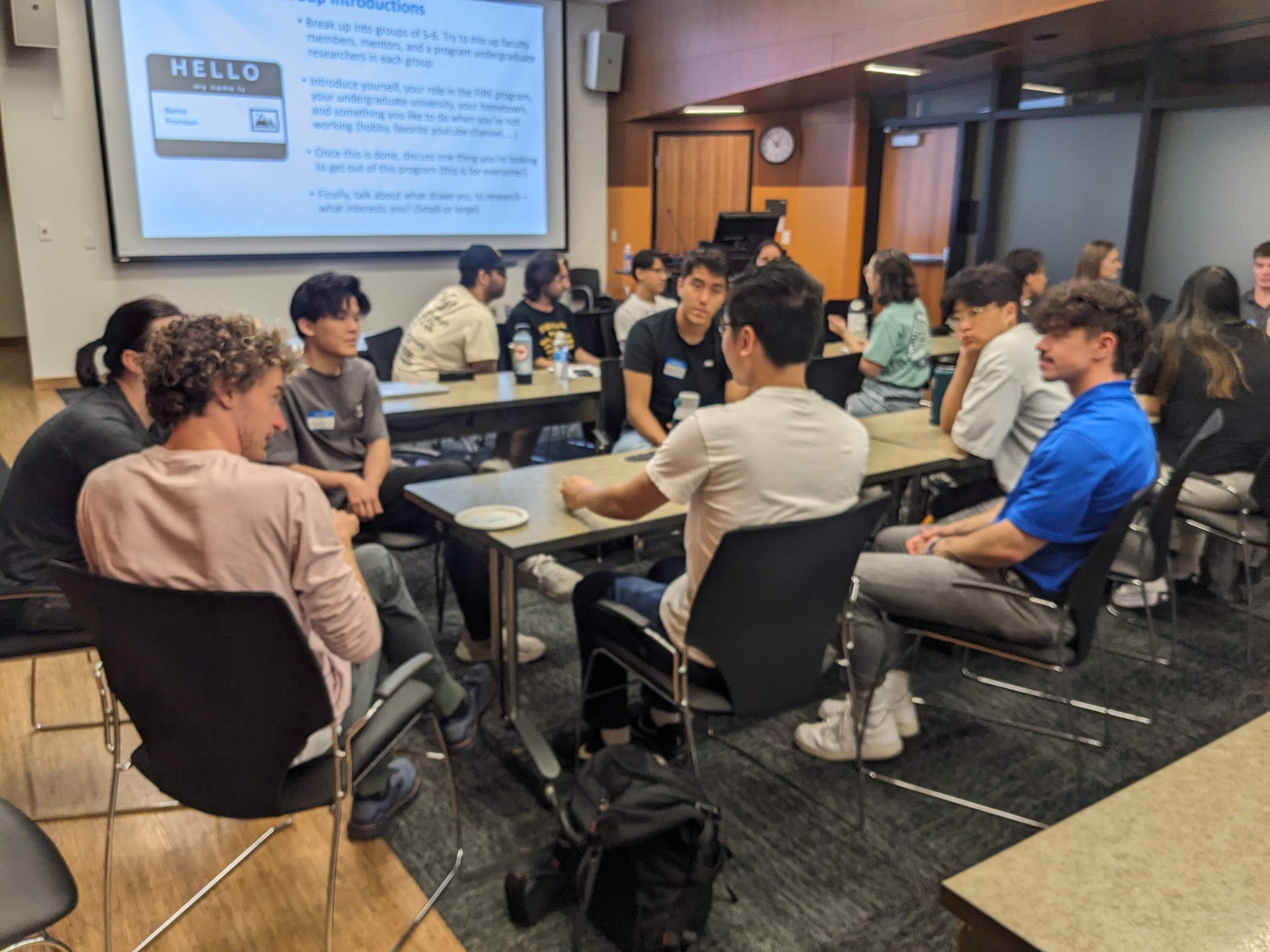 Students in a classroom setting sitting at large tables