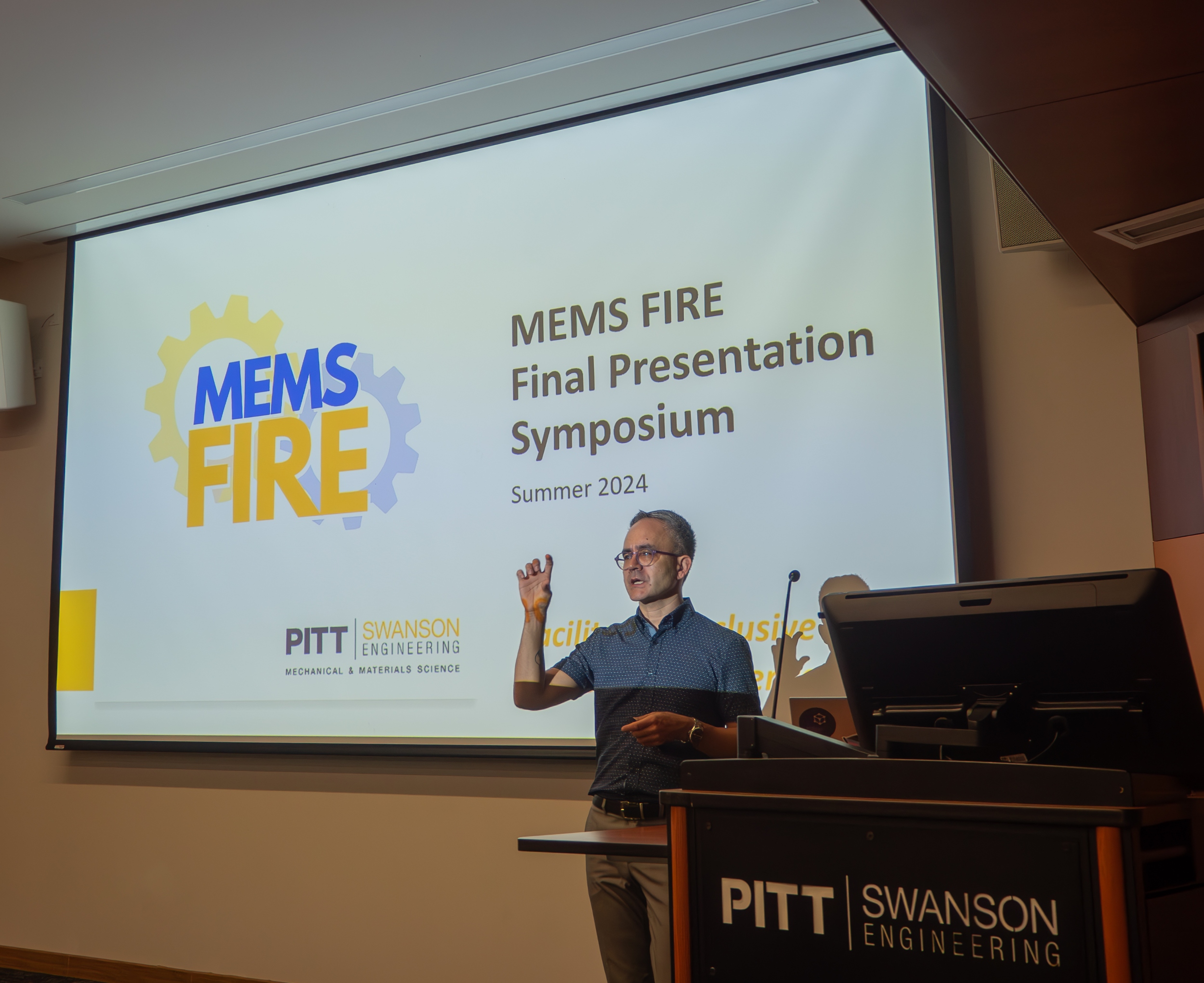 A professor presenting at the final presentation symposium for MEMS Fire