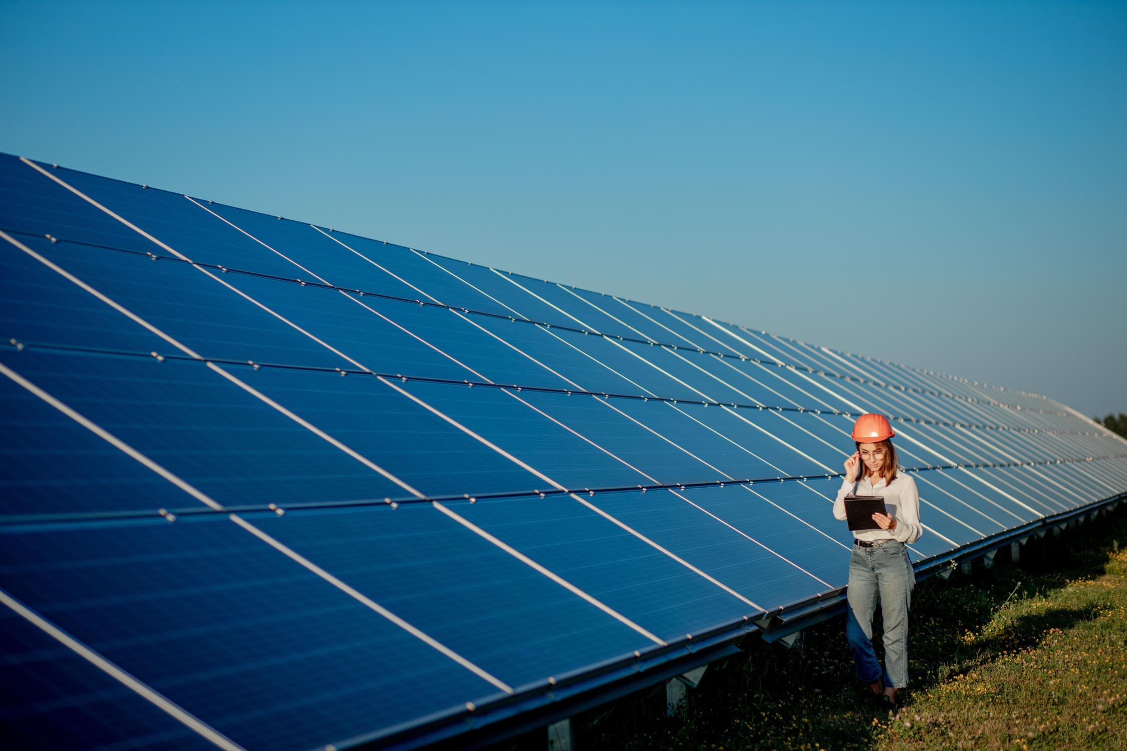 An engineer standing in front of solar panels