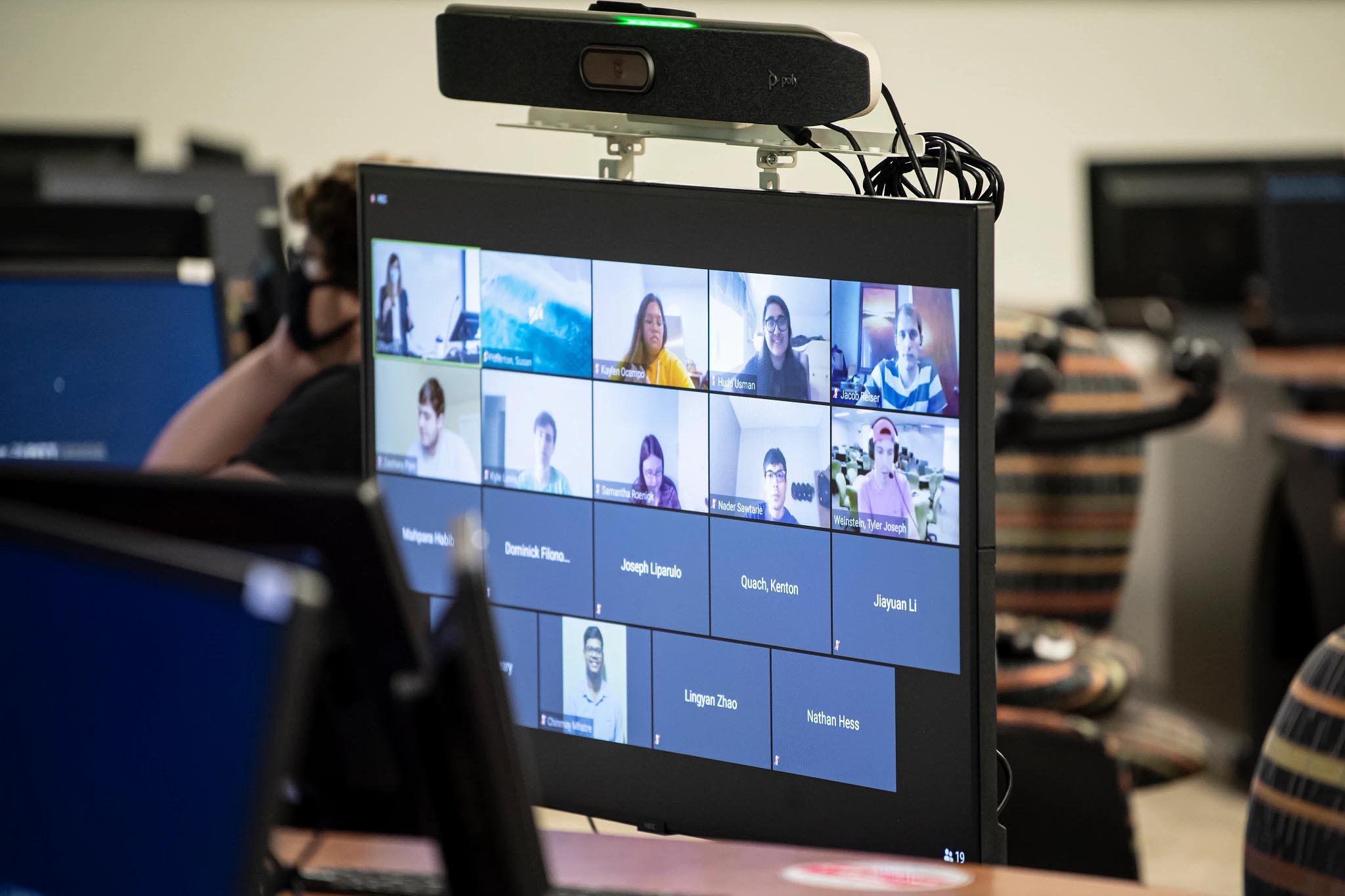 A zoom meeting on a monitor