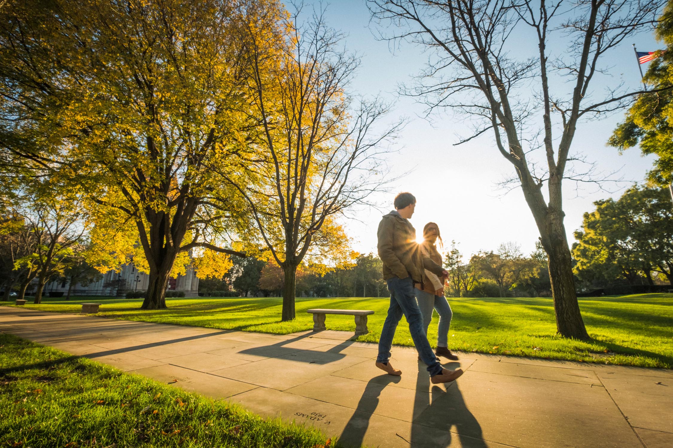 Students walking on campus in the fall