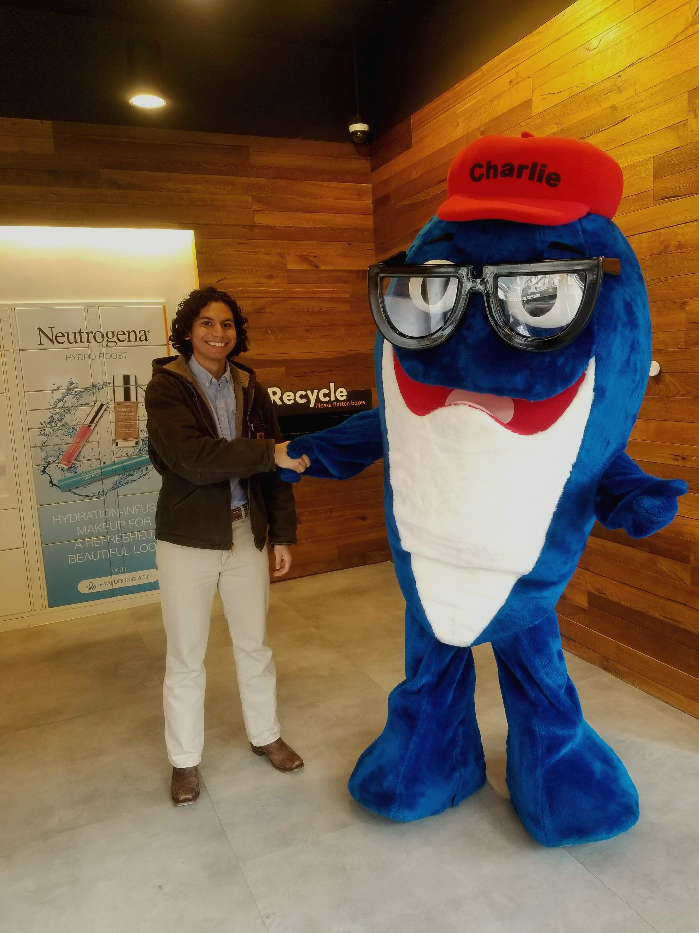 A person standing with the charlie tuna mascot