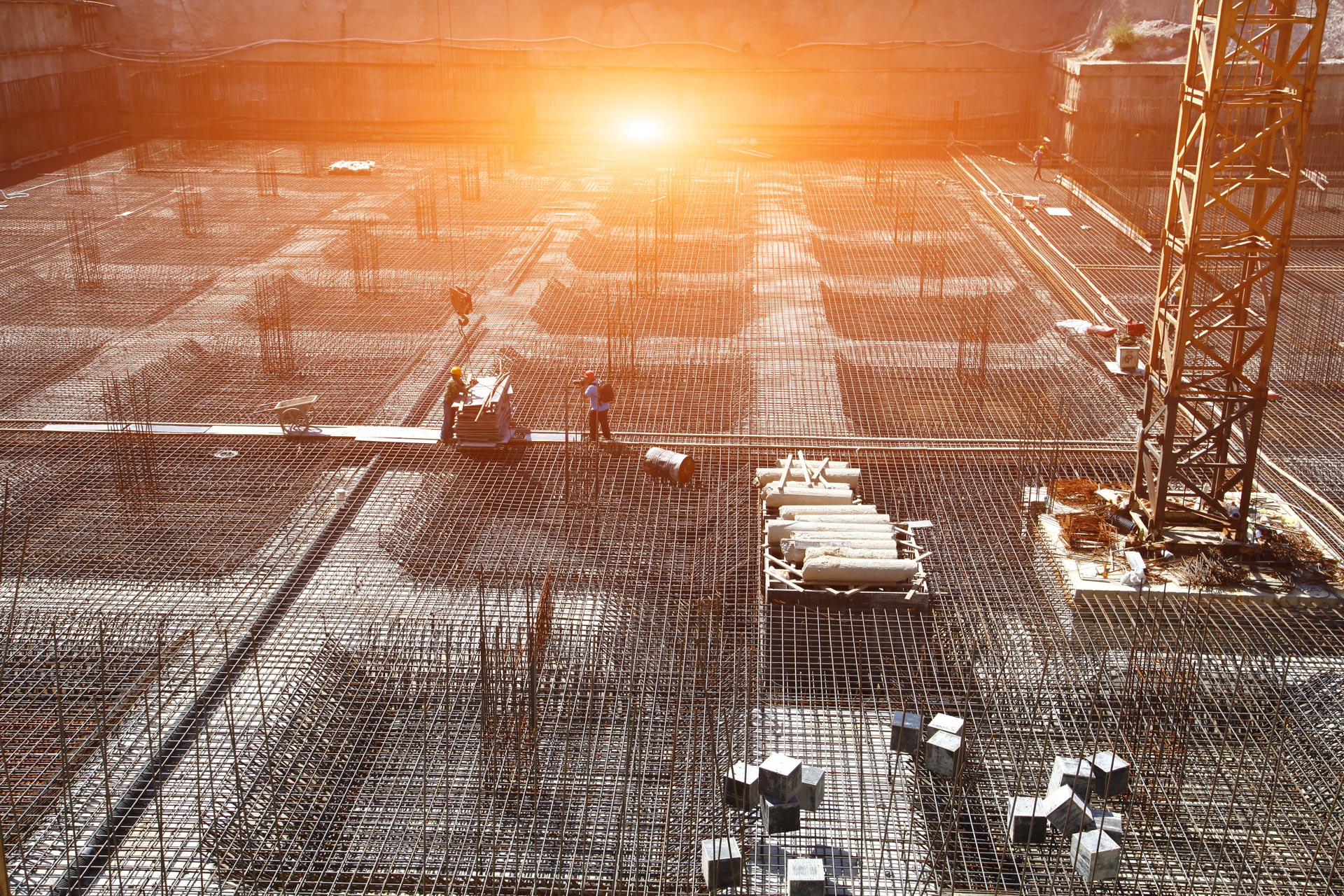 A large construction site with rebar and workers
